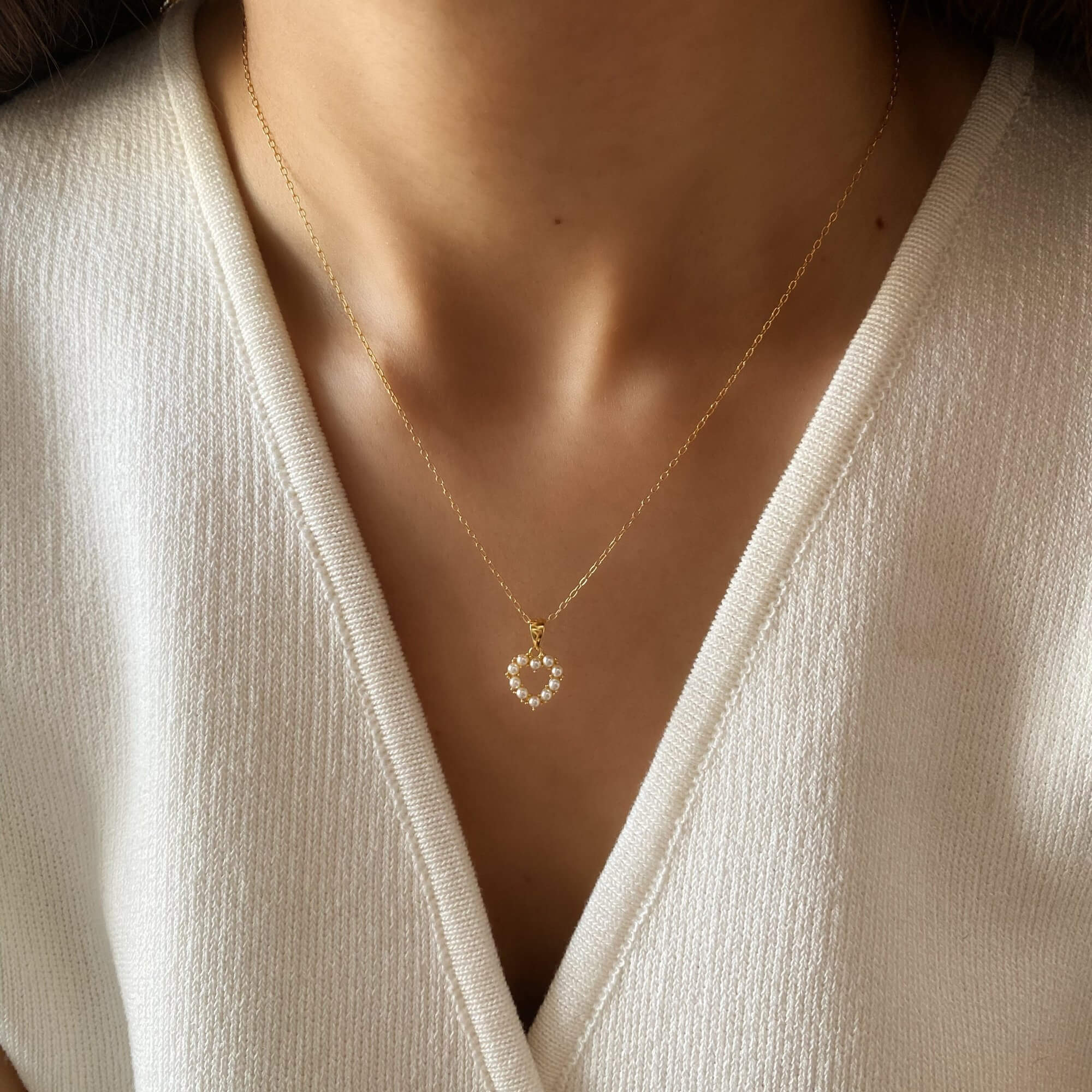 Alternative worn view of the KenaN pearl heart pendant necklace by Kampy Designs, capturing its elegant drape and classic charm.