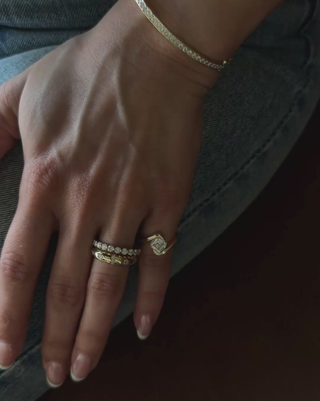 asscher cut pinky ring styled with minimal jewelry on model hand by Kampy