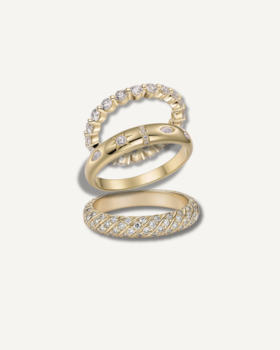 Moissanite ring stack set in gold finish on neutral background, Kampy Designs
