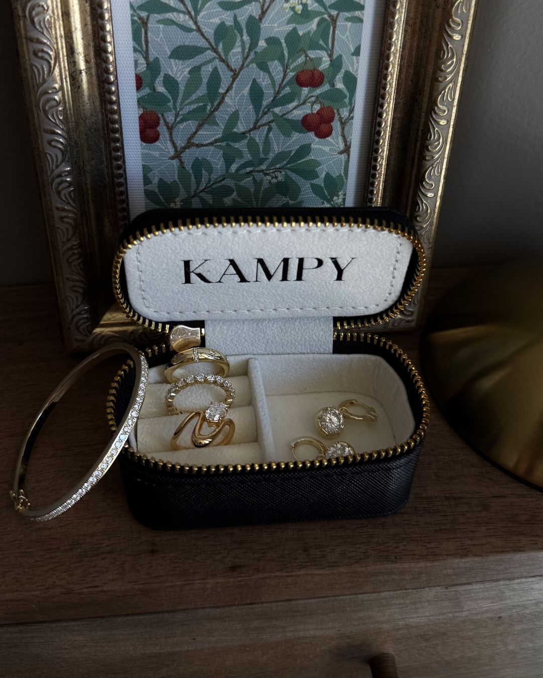 Oval moissanite pinky ring placed inside a compact travel jewelry case with organized compartments