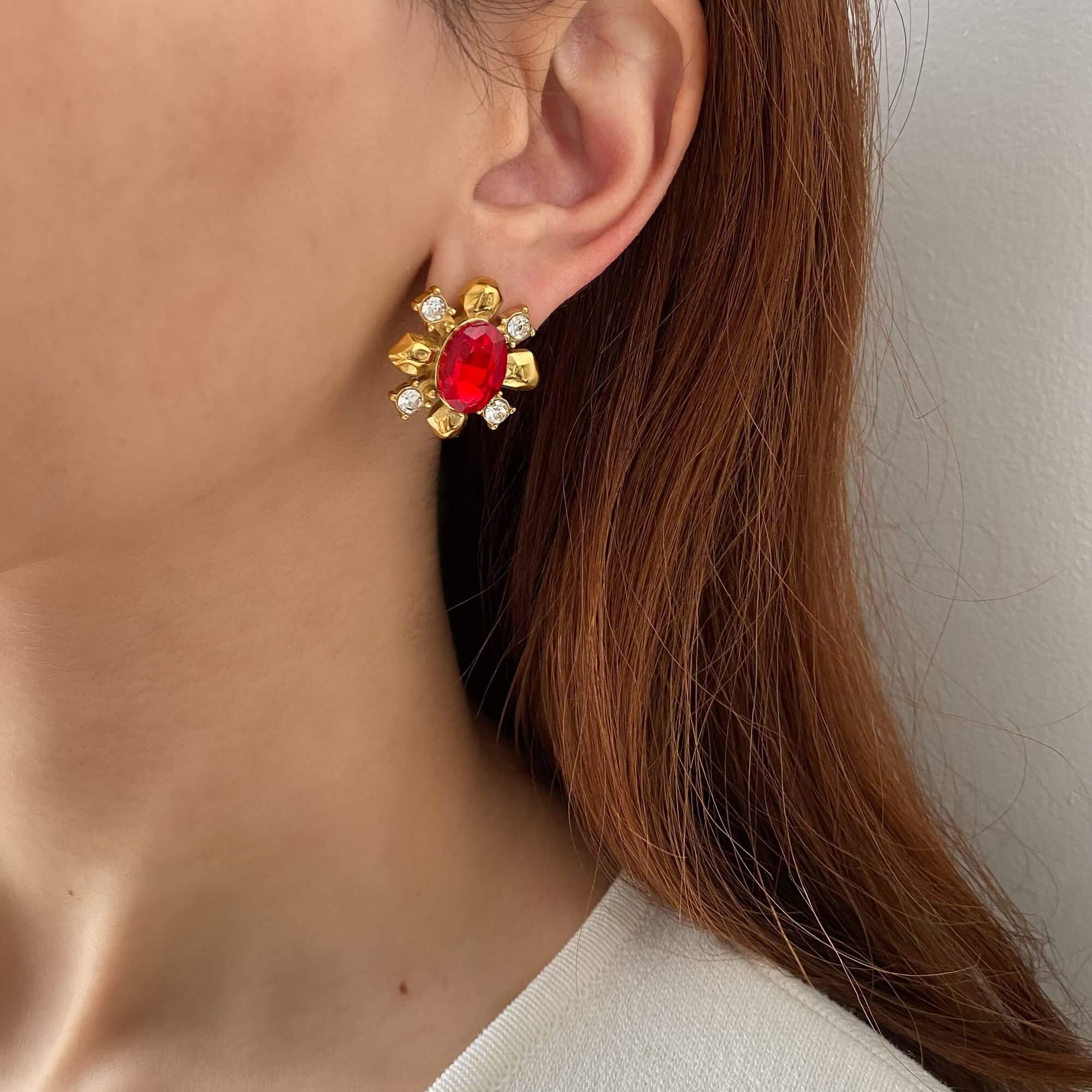 The KarnaraE vintage garnet stud earrings by Kampy Designs, worn on a model, highlighting their timeless beauty and rich garnet stone color.