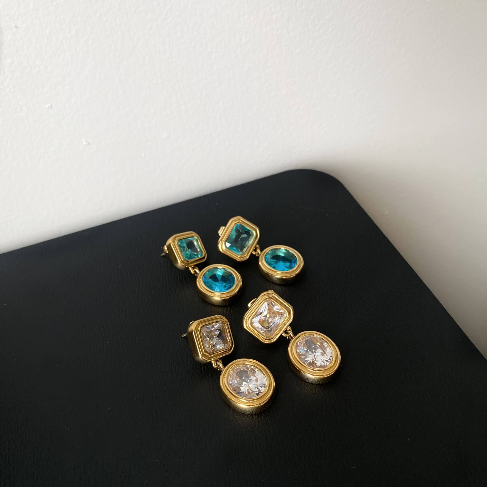 KosaE vintage-inspired dangle earrings by Kampy Designs, combining timeless teardrop styling with gemstone flair in aquamarine and clear options.
