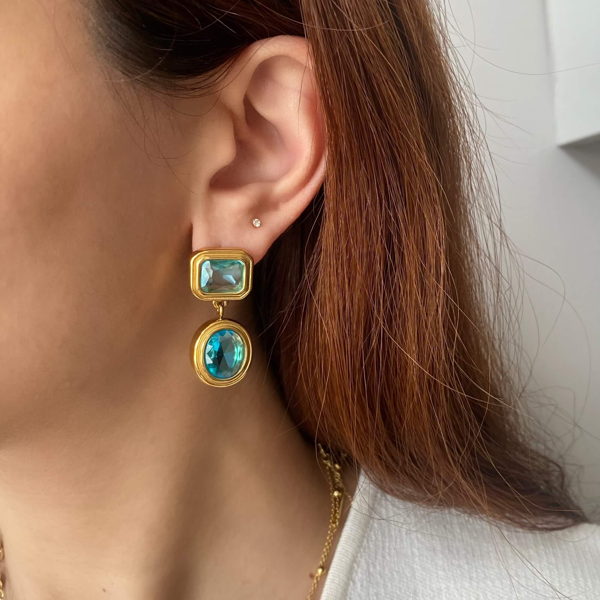 Close-up of KosaE vintage-inspired aquamarine dangle earrings by Kampy Designs, showing the soft blue gemstone and antique-style gold detailing.