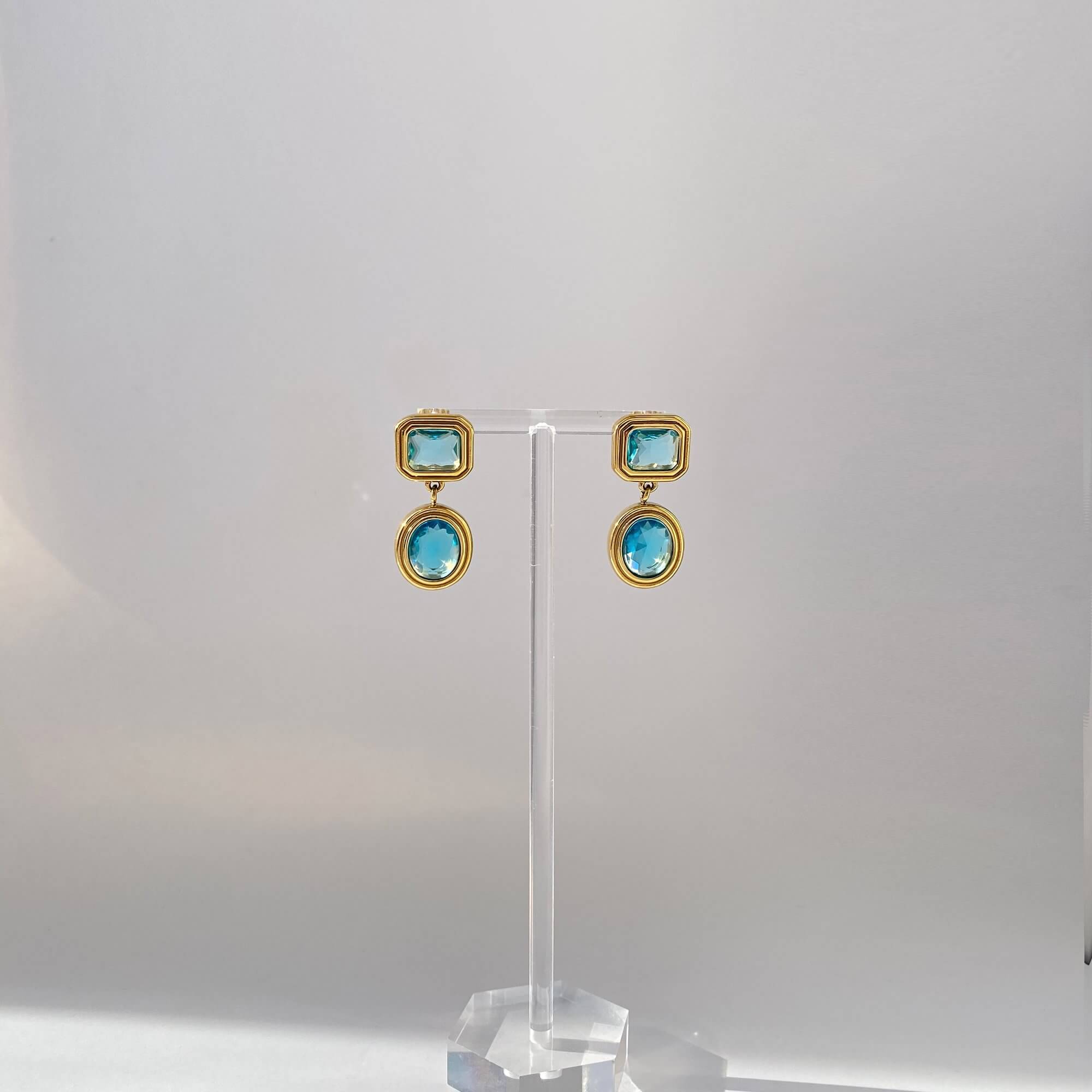 Front-facing view of KosaE aquamarine dangle earrings by Kampy Designs, featuring a vintage-style drop and pale gemstone centerpiece.